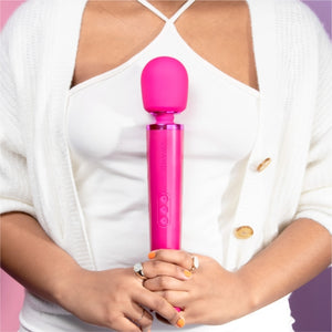 Wand vibrator, girl holding magenta pink le wand massage vibrator, best wand massager, magic rechargeable wand vibrators, vibration therapy tool, what is the best wand vibrator, powerful vibrator, magic wand vibrators buyers guide, is the wand massager a vibrator?, rechargeable magic wand vibrator review, best vibrator, le wand vibes, best vibrators, how to use a vibrator, bdsm wand, massage wand tool