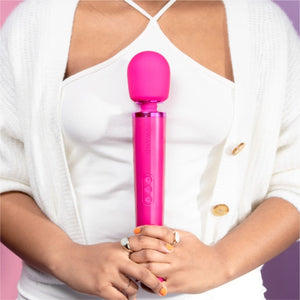 Wand vibrator, girl holding magenta pink le Wand massage vibrator, best wand massager, magic rechargeable wand vibrators, vibration therapy tool, what is the best wand vibrator, powerful vibrator, magic wand vibrators buyers guide, is the wand massager a vibrator?, rechargeable magic wand vibrator review, best vibrator, le wand vibes, best vibrators, how to use a vibrator, bdsm wand, massage wand tool